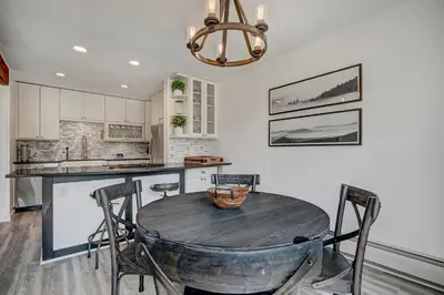 a kitchen with a table with chairs and a dining room at Mountain luxury on Lake Dillon, close to all the best ski resorts in Colorado! in Dillon