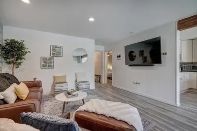 a living room with a couch and a tv on a wall at Mountain luxury on Lake Dillon, close to all the best ski resorts in Colorado! in Dillon