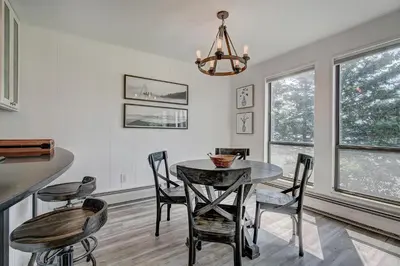 a dining room with a table and chairs at Mountain luxury on Lake Dillon, close to all the best ski resorts in Colorado! in Dillon