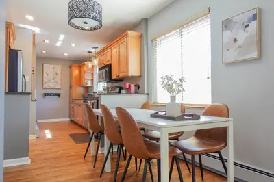 a kitchen and dining room with a white table and chairs at Family-Friendly Retreat 30-Night Minimal in Denver