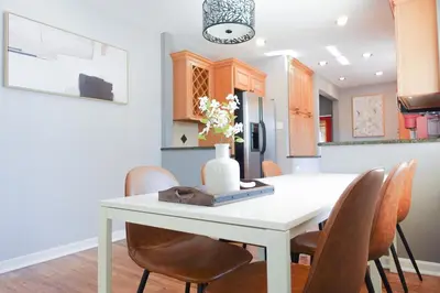 a kitchen and dining room with a white table and chairs at Family-Friendly Retreat 30-Night Minimal in Denver