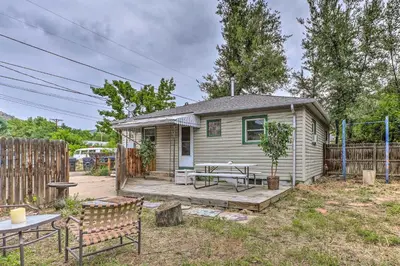 a small house with a table and benches in a yard at Relaxing Golden Getaway with Grill Less Than 1 Mi to Town! in Golden