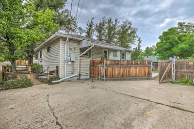 a house with a wooden fence in front of it at Relaxing Golden Getaway with Grill Less Than 1 Mi to Town! in Golden
