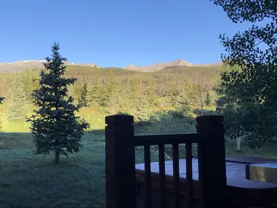 a wooden fence with a christmas tree in a field at Highland Greens Oak Retreat townhouse in Breckenridge