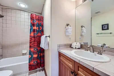 a bathroom with a sink and a shower at Highland Greens Oak Retreat townhouse in Breckenridge