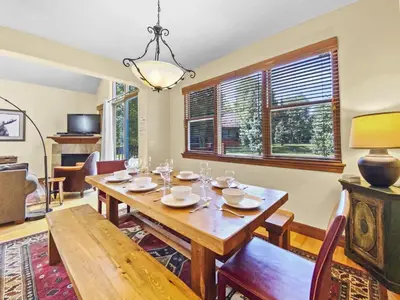 a dining room with a wooden table and chairs at Highland Greens Oak Retreat townhouse in Breckenridge