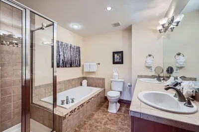 a bathroom with a tub and a toilet and a sink at Highland Greens Oak Retreat townhouse in Breckenridge