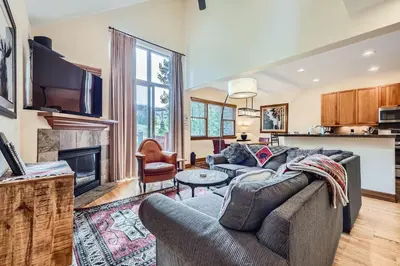 a living room with a couch and a tv at Highland Greens Oak Retreat townhouse in Breckenridge