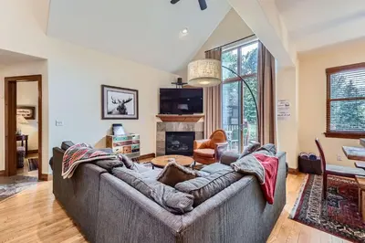 a living room with a couch and a fireplace at Highland Greens Oak Retreat townhouse in Breckenridge