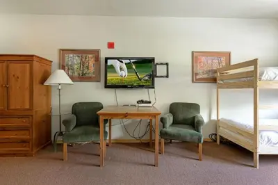 a room with a bed and a desk with two chairs and a tv at Gateway Mountain Lodge 5029 - Keystone in Keystone