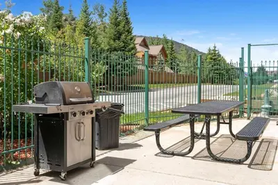a grill and a picnic table next to a fence at Gateway Mountain Lodge 5029 - Keystone in Keystone