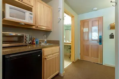 a kitchen with a sink and a microwave and a door at Gateway Mountain Lodge 5029 - Keystone in Keystone