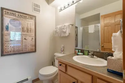 a bathroom with a sink and a toilet and a mirror at Watch Hill #524 - Wildernest in Silverthorne