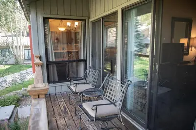 two chairs sitting on the porch of a house at 1196 Flying Dutchman condo in Keystone