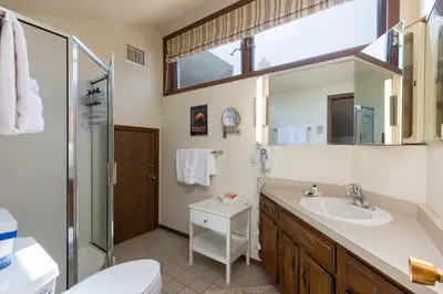 a bathroom with a sink and a toilet and a mirror at 1196 Flying Dutchman condo in Keystone