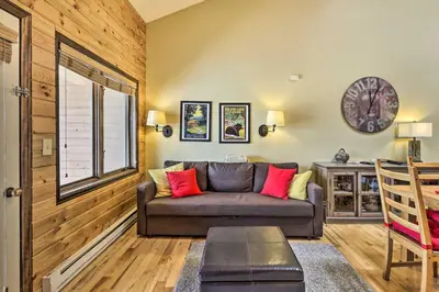 a living room with a couch and a window at Cozy Granby Mountain Condo with Resort Amenities! in Granby