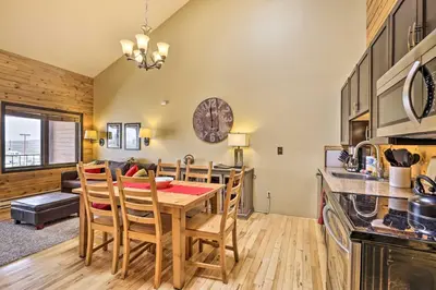 a kitchen and dining room with a table and chairs at Cozy Granby Mountain Condo with Resort Amenities! in Granby