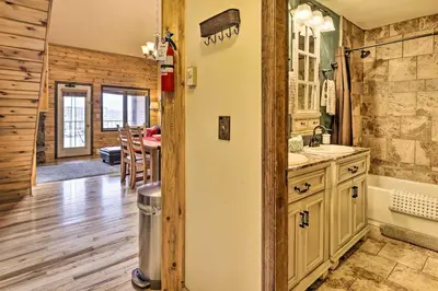 a kitchen and dining room in a log cabin at Cozy Granby Mountain Condo with Resort Amenities! in Granby