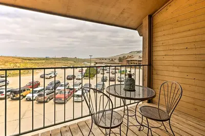 a balcony with a table and chairs and a parking lot at Cozy Granby Mountain Condo with Resort Amenities! in Granby