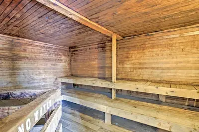 an empty wooden sauna with wooden benches in it at Cozy Granby Mountain Condo with Resort Amenities! in Granby