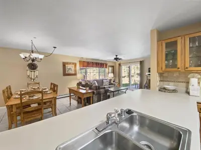 a kitchen with a sink and a living room at Swans Nest Villa 1304 condo in Breckenridge