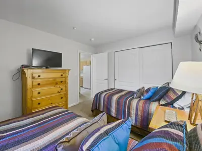 a bedroom with two beds and a dresser at Swans Nest Villa 1304 condo in Breckenridge