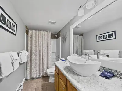a bathroom with a sink and a tub and a toilet at Swans Nest Villa 1304 condo in Breckenridge