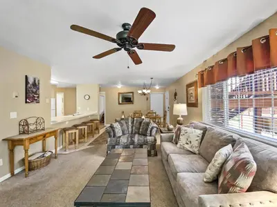 a living room with a couch and a ceiling fan at Swans Nest Villa 1304 condo in Breckenridge
