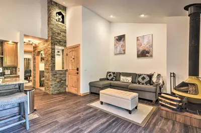 a living room with a couch and a fireplace at Estes Park Condo about 1 Mi to RMNP! in Estes Park