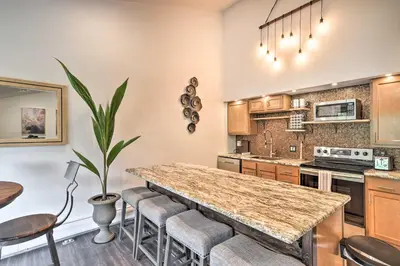 a kitchen with a large island with bar stools at Estes Park Condo about 1 Mi to RMNP! in Estes Park
