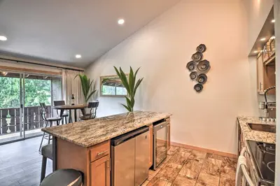 a kitchen with an island with a counter top at Estes Park Condo about 1 Mi to RMNP! in Estes Park