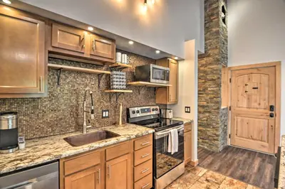 a kitchen with a sink and a stove top oven at Estes Park Condo about 1 Mi to RMNP! in Estes Park