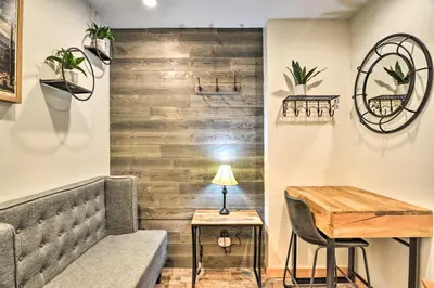 a room with a couch and a table with a lamp at Estes Park Condo about 1 Mi to RMNP! in Estes Park