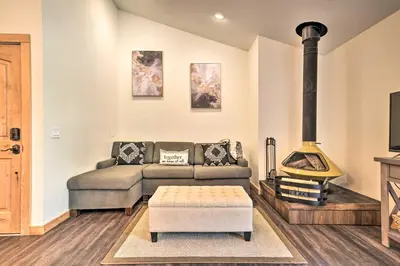 a living room with a couch and a stove at Estes Park Condo about 1 Mi to RMNP! in Estes Park