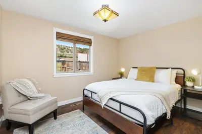 a bedroom with a bed and a chair and a window at Hidden Valley Retreat Quiet Escape with Mountain Views in Loveland