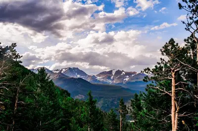 a view of a mountain range with trees and clouds at Hidden Valley Retreat Quiet Escape with Mountain Views in Loveland