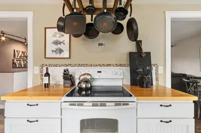 a kitchen with a stove and pots and pans on the wall at Hidden Valley Retreat Quiet Escape with Mountain Views in Loveland