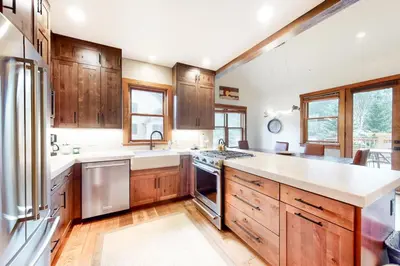 a kitchen with wooden cabinets and stainless steel appliances at Red Hawk Townhome 2350 in Keystone