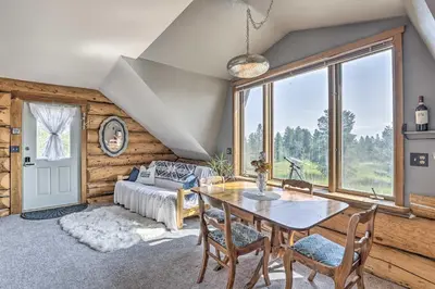 a living room with a table and a bed at Fraser Couples Hideaway with Indian Peaks View in Fraser