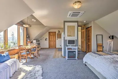 a bedroom with a bed and a dining room with a table at Fraser Couples Hideaway with Indian Peaks View in Fraser