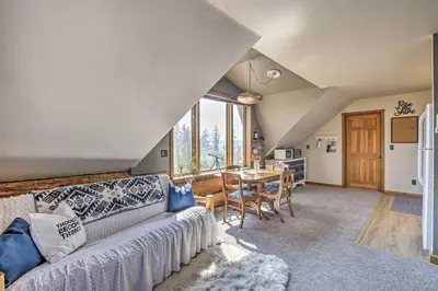 a living room with a couch and a table at Fraser Couples Hideaway with Indian Peaks View in Fraser
