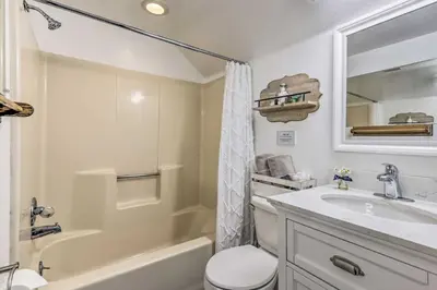 a bathroom with a sink and a toilet and a tub at Fraser Couples Hideaway with Indian Peaks View in Fraser