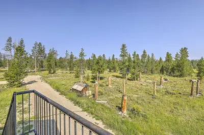 a path in a field with a fence and trees at Fraser Couples Hideaway with Indian Peaks View in Fraser