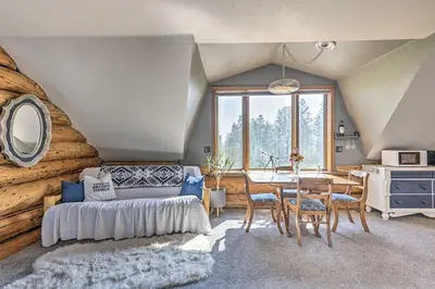 a room with a bed and a table with chairs at Fraser Couples Hideaway with Indian Peaks View in Fraser