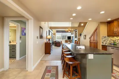 a kitchen with a counter and a bar with stools at 2105 The Pines condo in Keystone