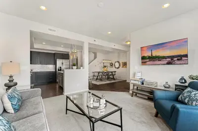 a living room with a blue couch and a table at Centrally Located, Comfortable Home in Music City in Fort Collins