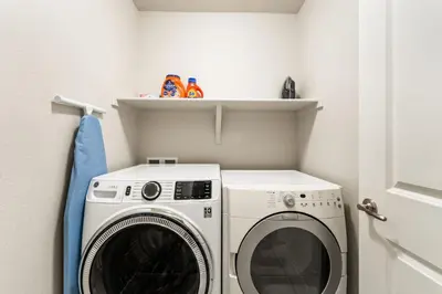 a laundry room with a washer and dryer at Centrally Located, Comfortable Home in Music City in Fort Collins
