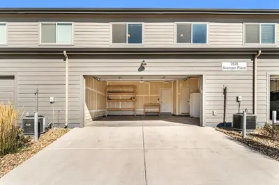 a building with a garage with a driveway at Centrally Located, Comfortable Home in Music City in Fort Collins