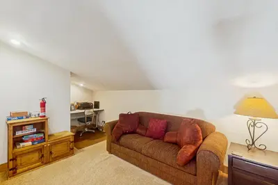 a living room with a brown couch and a lamp at Mountain Dreams Condo in Fraser