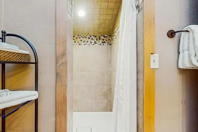 a bathroom with a shower with a shower curtain at Mountain Dreams Condo in Fraser